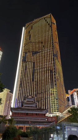 Yuzhong District lit up at night — streets, towers, and neon