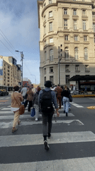 Evening street life captured in Buenos Aires crosswalk area
