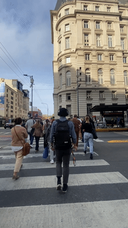 Evening street life captured in Buenos Aires crosswalk area