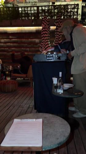 Evening rooftop gathering with DJ documented in Cape Town