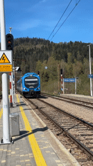 Train arrives at Wisła station as passengers gather platform