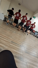 Synchronized dance rehearsal in matching maroon uniforms