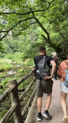 Drone operator and walkers enjoy scenic riverside in Luoguta
