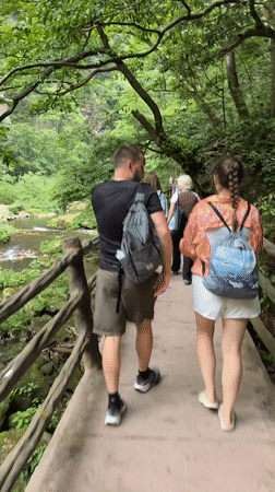 Drone operator and walkers enjoy scenic riverside in Luoguta