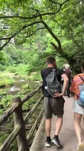 Drone operator and walkers enjoy scenic riverside in Luoguta