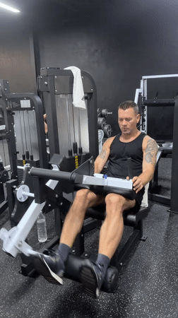 Gym users exercise on leg equipment in Choeng Mon