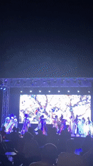 Colorful outdoor dance performance on a lit Kemer stage
