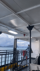 Passenger gazes at islands from ship near Thailand