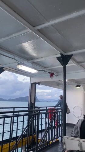 Passenger gazes at islands from ship near Thailand