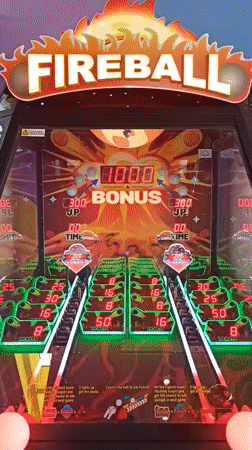 Inside a Bari arcade packed with game cabinets and color