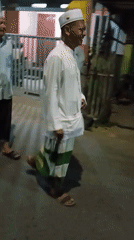 Nighttime Islamic gathering in Banjarmasin with ceremonial goods