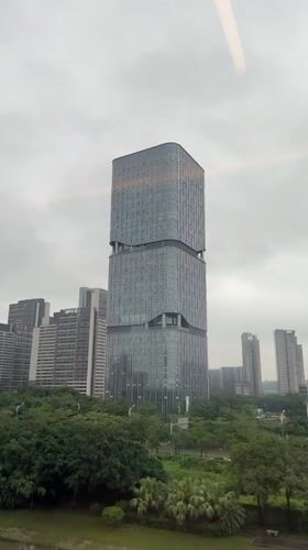Train passenger films distinctive stacked skyscraper in Panyu District