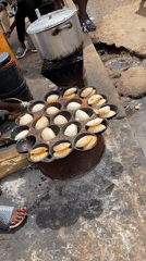 Street food vendors cook pancake snacks in Bukuru Nigeria