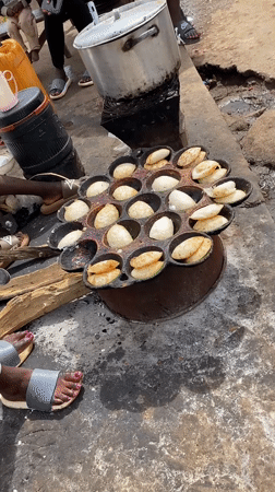 Street food vendors cook pancake snacks in Bukuru Nigeria