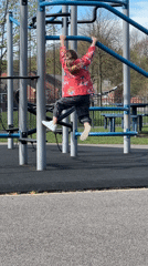Children play on playground equipment in Macclesfield