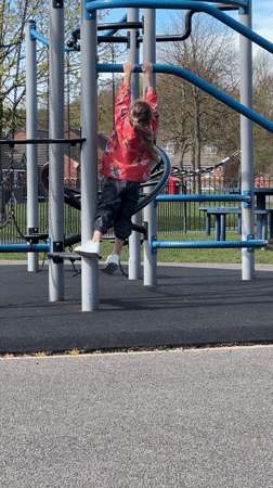Children play on playground equipment in Macclesfield