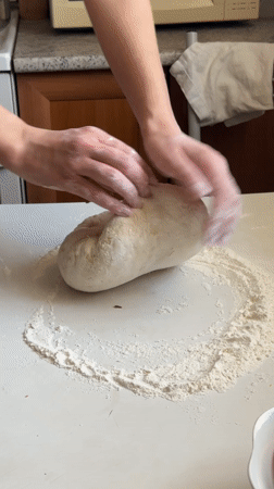Woman prepares homemade dough in Surgut kitchen