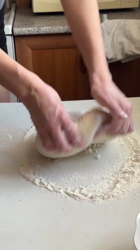 Woman prepares homemade dough in Surgut kitchen