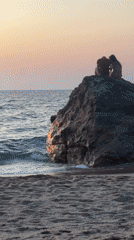 Golden hour on the Biarritz shoreline, figures on the rocks