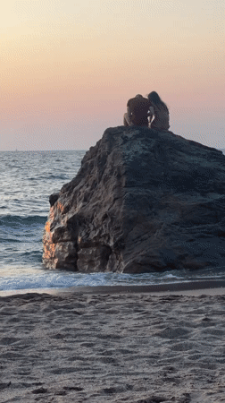 Golden hour on the Biarritz shoreline, figures on the rocks
