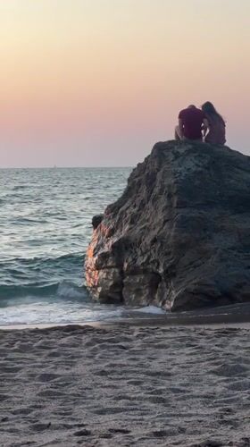 Golden hour on the Biarritz shoreline, figures on the rocks