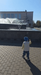 Family enjoys sunny morning at Chaikovsky fountain with toddler