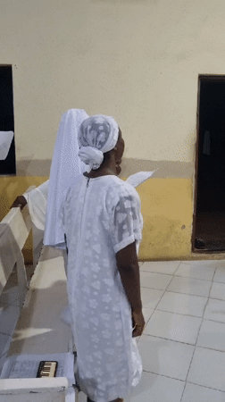 Evening worship service in white attire, Lagos church