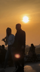Street musician performs as crowds gather for sunset in Belgrade