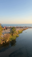 Alanya beachfront at golden hour — promenade, palms, and sunset
