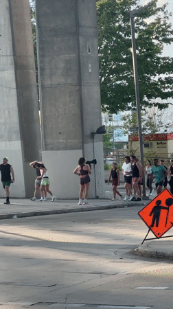 Athletic group gathers under Vancouver bridge with megaphone leader