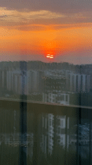 Dramatic orange sunset captured over Kudrovo city skyline