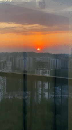 Dramatic orange sunset captured over Kudrovo city skyline
