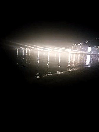 Budva waterfront at night, lights reflecting on the shore