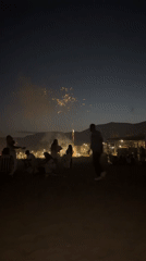 Fireworks and crowds on Castelldefels beach on a summer night