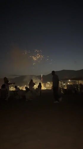 Fireworks and crowds on Castelldefels beach on a summer night