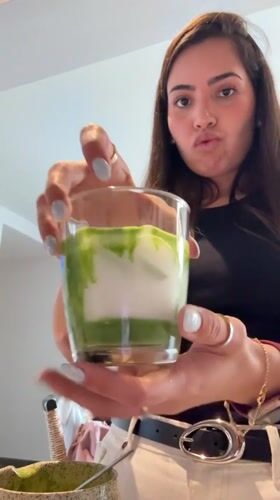 Woman prepares matcha tea and steak dinner in Mexican kitchen
