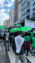 ATE union members march through Buenos Aires with green banners