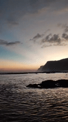Dawn at a rocky Kuta Selatan beach, waves, crabs, and coastline