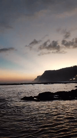 Dawn at a rocky Kuta Selatan beach, waves, crabs, and coastline