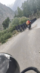 Rider in orange jacket spotted ahead on a Karing road