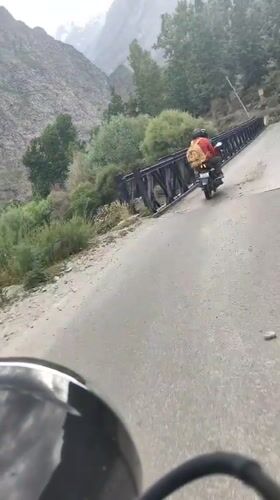 Rider in orange jacket spotted ahead on a Karing road
