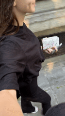 Woman walks with wallet and pen in Sofia morning