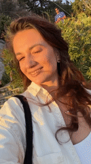 Woman records selfie video in golden light in Athens