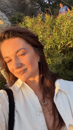 Woman records selfie video in golden light in Athens