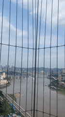City skyline viewed through fence in Yuzhong District