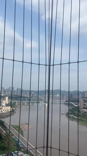 City skyline viewed through fence in Yuzhong District