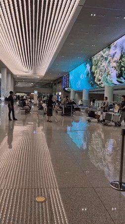 Moving through Incheon Airport terminal with gold suitcase