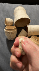 Person opens handmade cat-themed Matryoshka dolls in Florianópolis