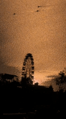 Ferris wheel sunset scene captured by boats in Pokhara