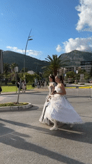 Formal-dressed women cross street in Budva Montenegro